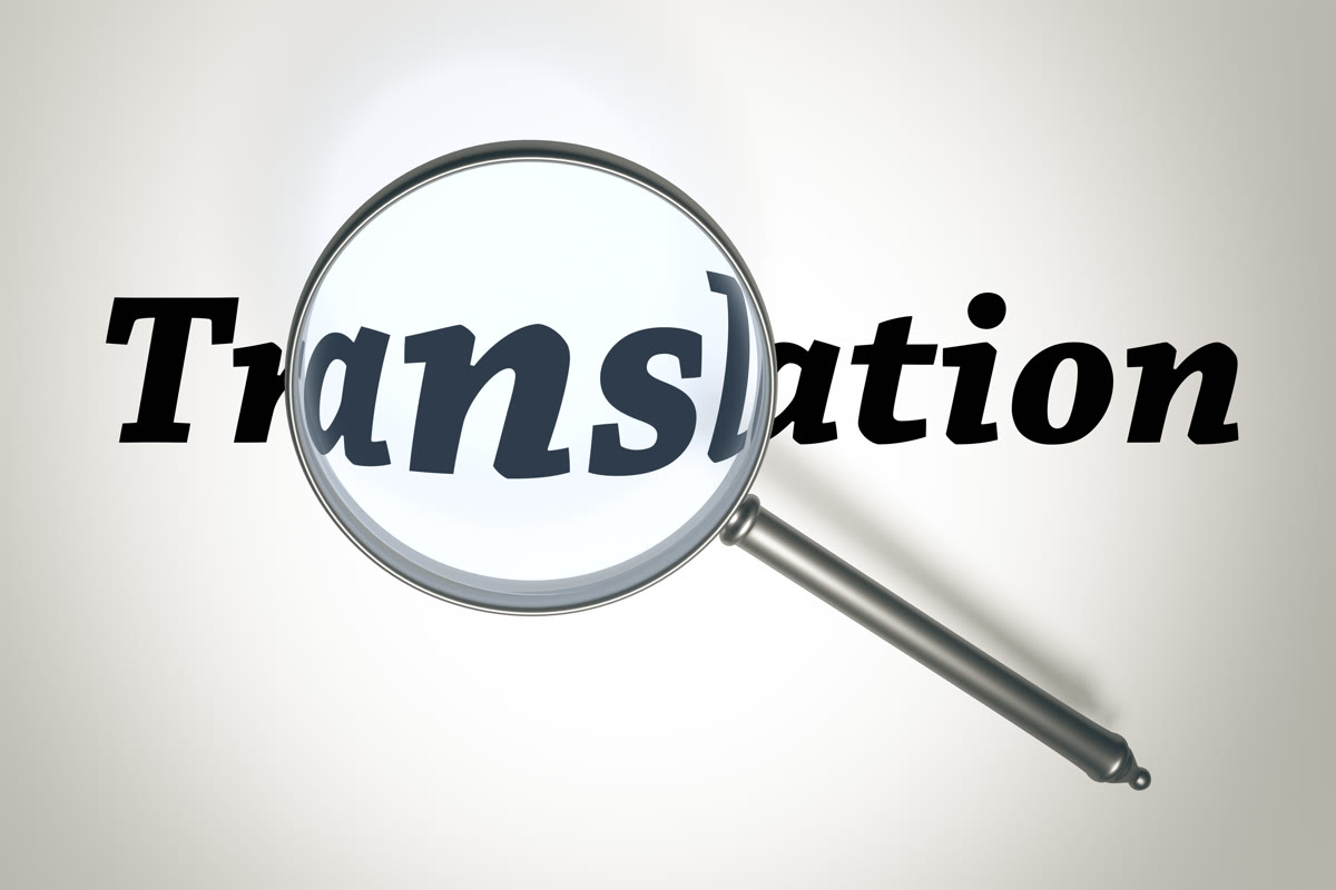 Translation 글자를 돋보기로 확대해 보여주는 이미지로 번역공증 단계의 정확도 확인을 나타내는 사진